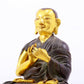 A serene gilt bronze statue of the master