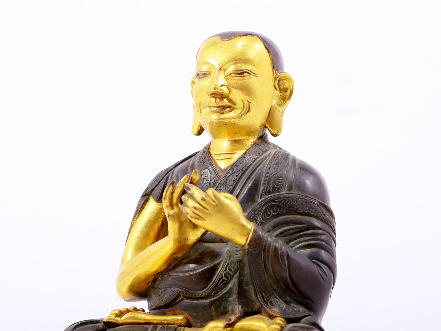 A serene gilt bronze statue of the master