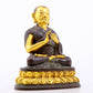 A serene gilt bronze statue of the master