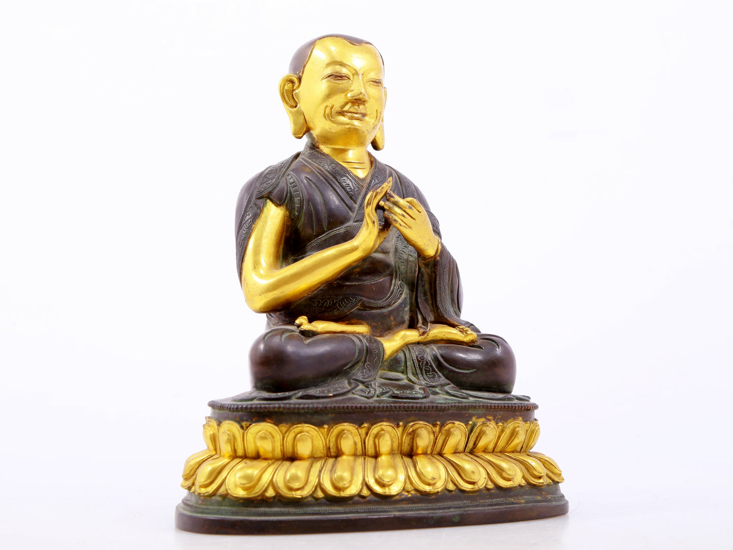 A serene gilt bronze statue of the master