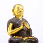 A serene gilt bronze statue of the master