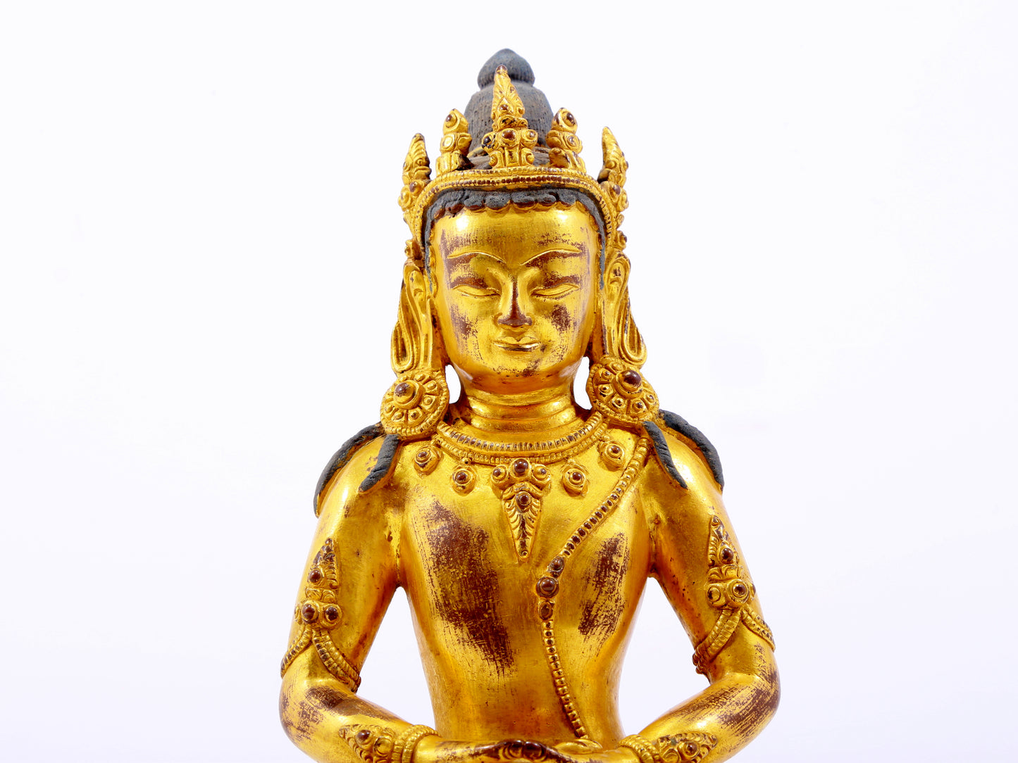 A serene gilt bronze statue of Amitayus Buddha