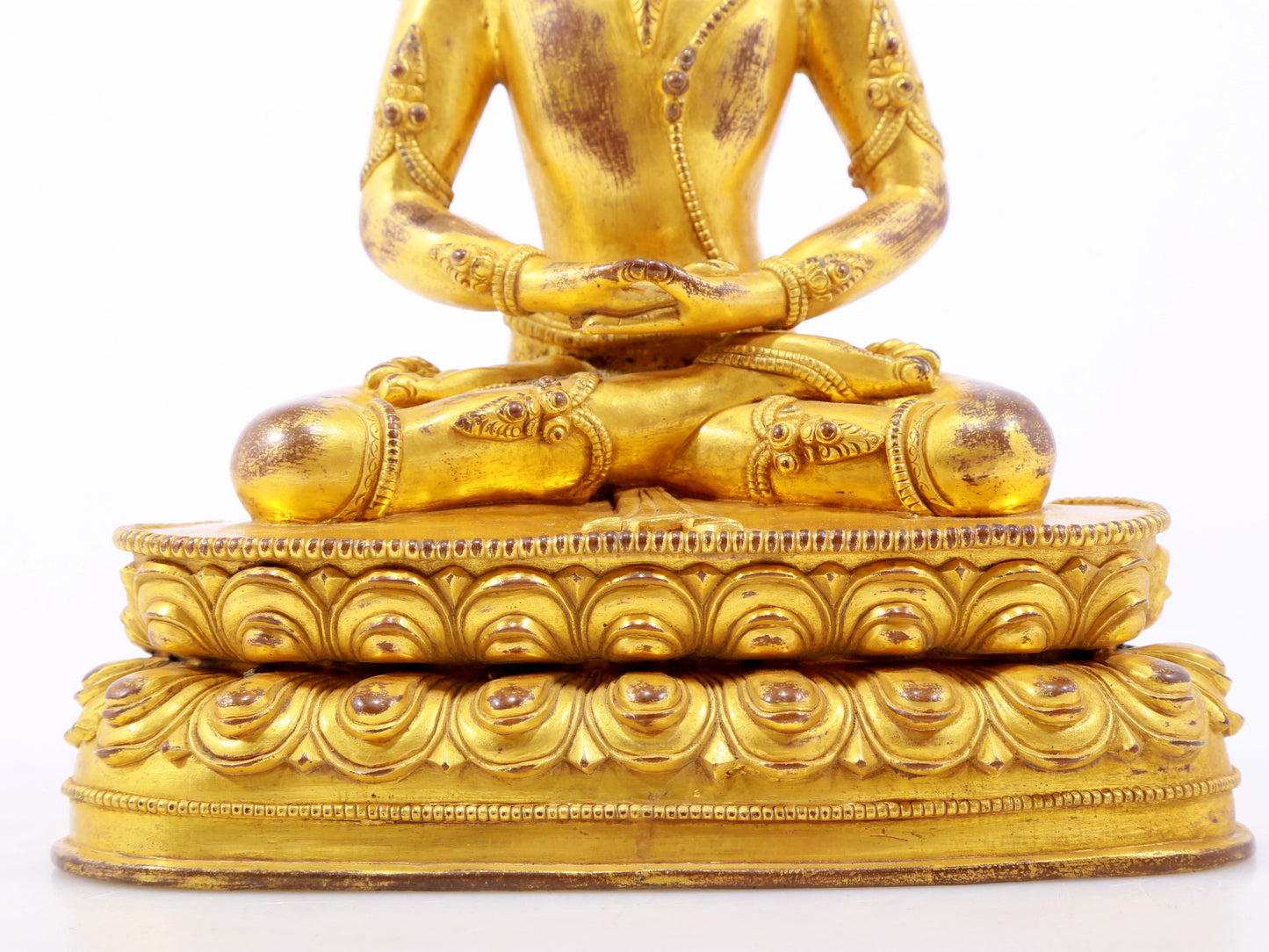 A serene gilt bronze statue of Amitayus Buddha