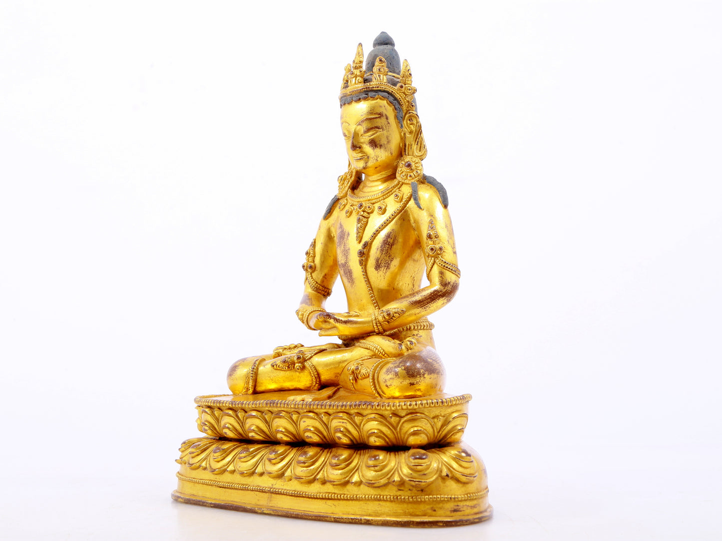 A serene gilt bronze statue of Amitayus Buddha