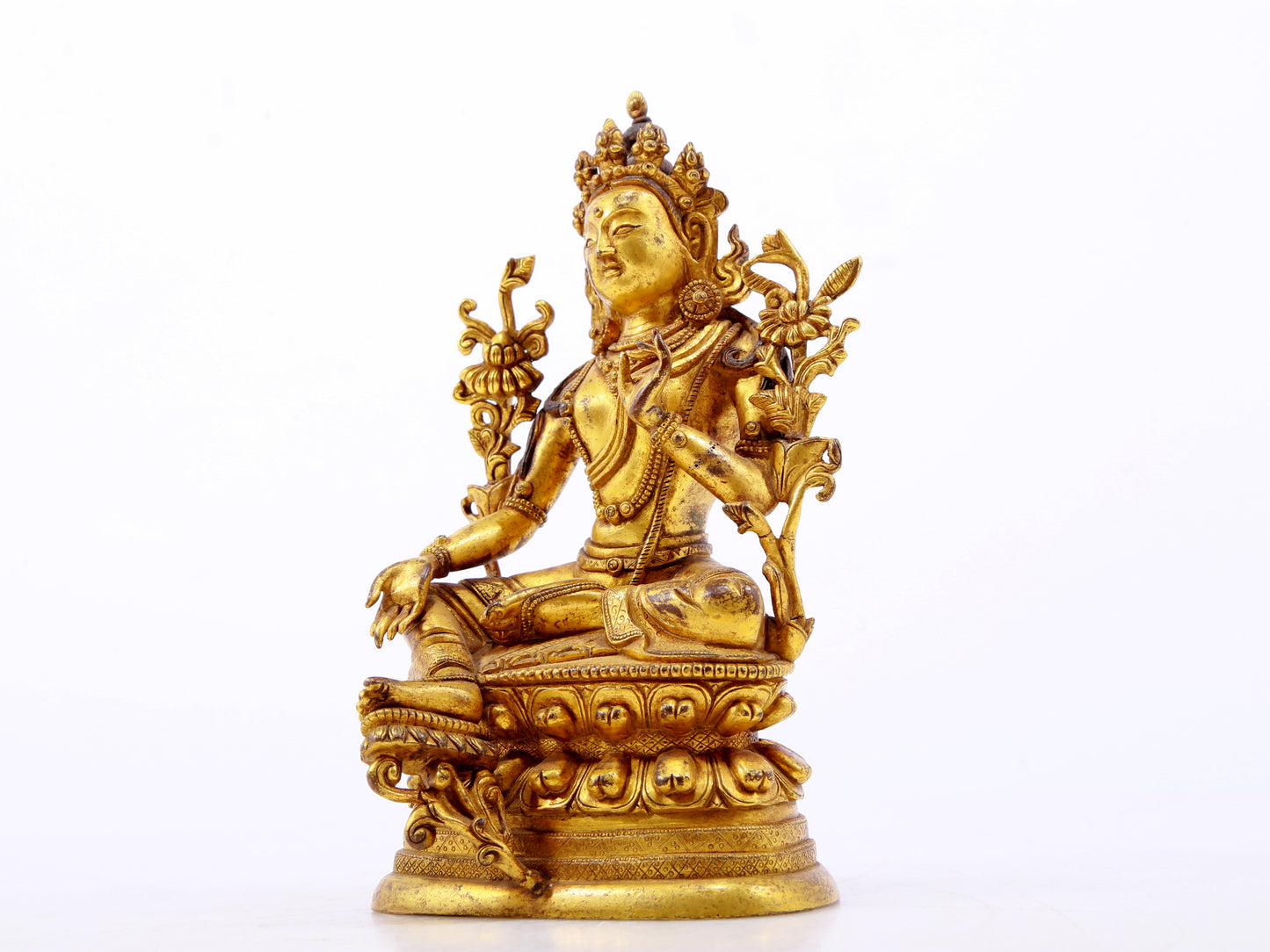 A serene gilt bronze green Tara statue