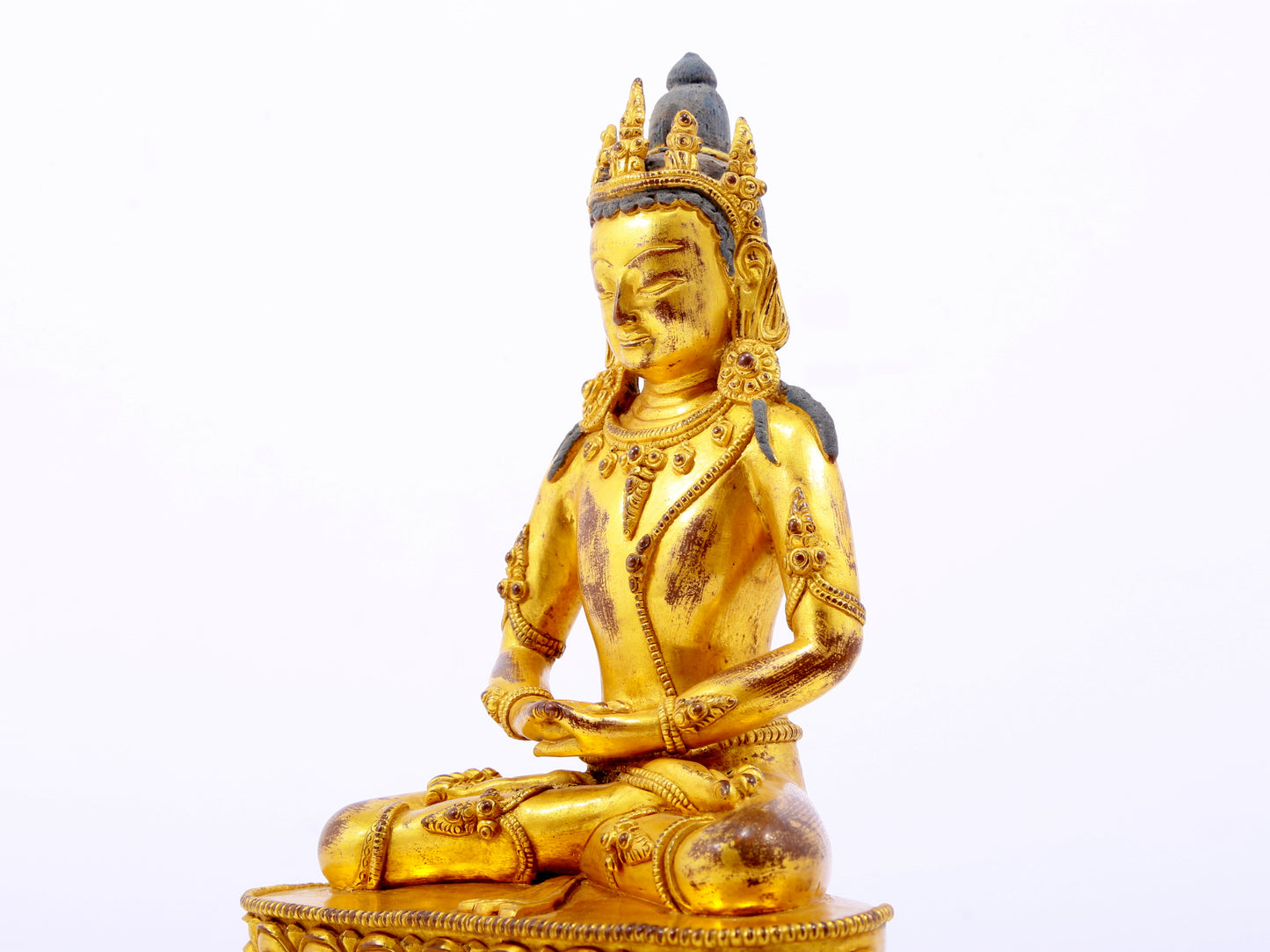 A serene gilt bronze statue of Amitayus Buddha