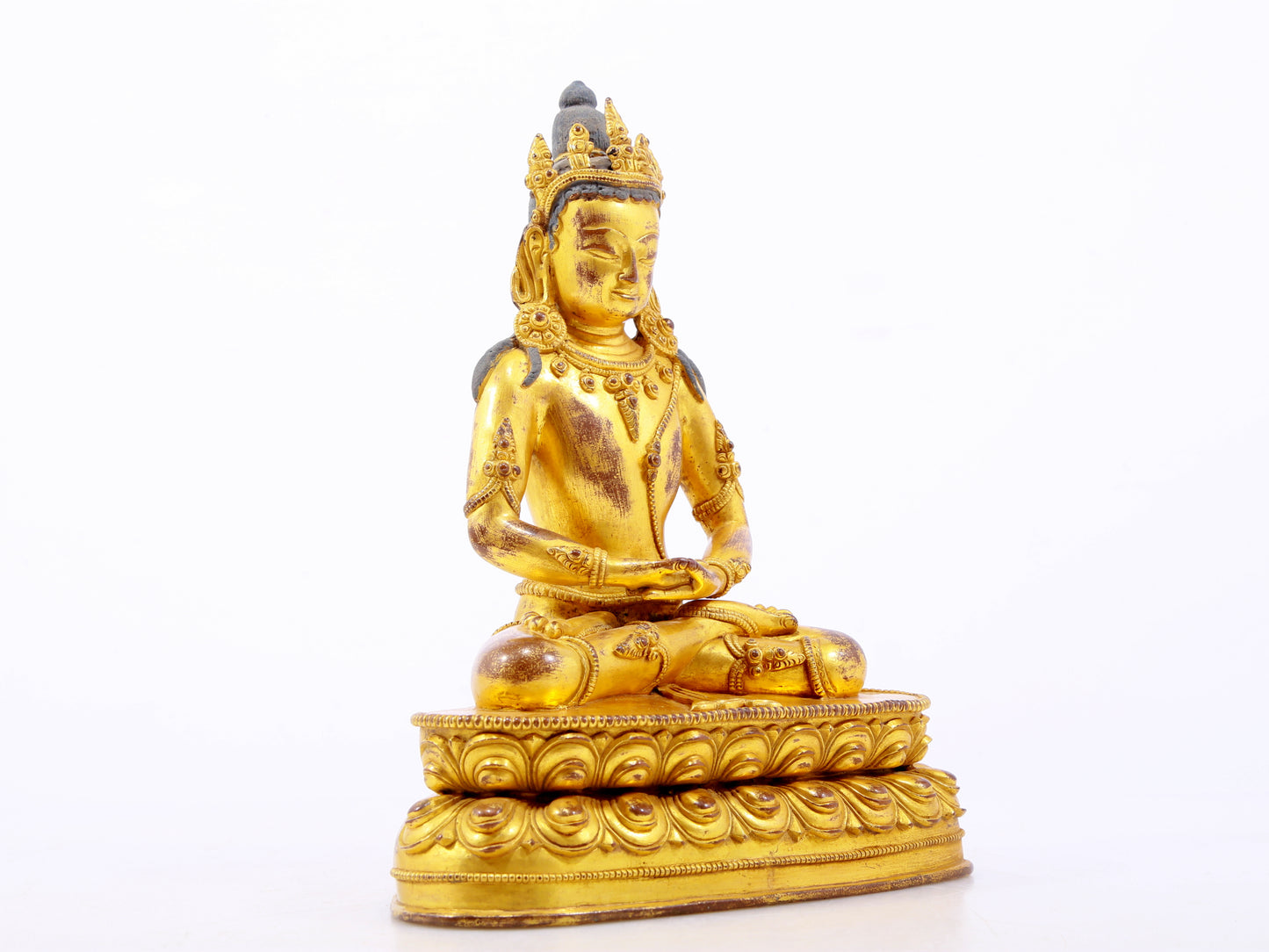 A serene gilt bronze statue of Amitayus Buddha