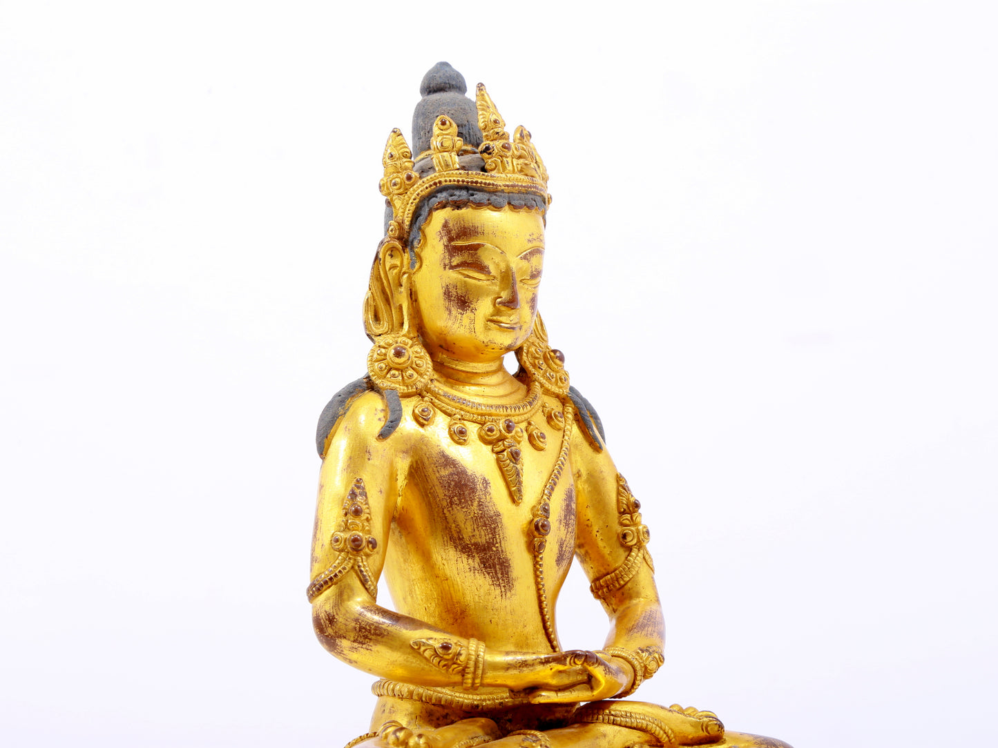 A serene gilt bronze statue of Amitayus Buddha