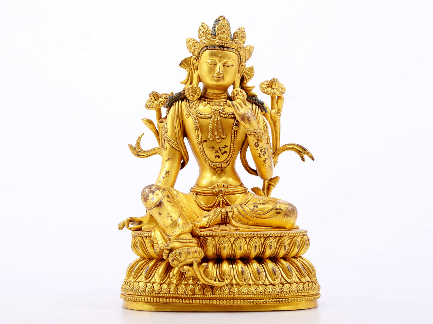 A serene gilt bronze green Tara statue