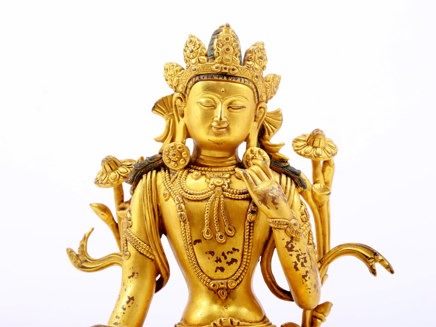 A serene gilt bronze green Tara statue