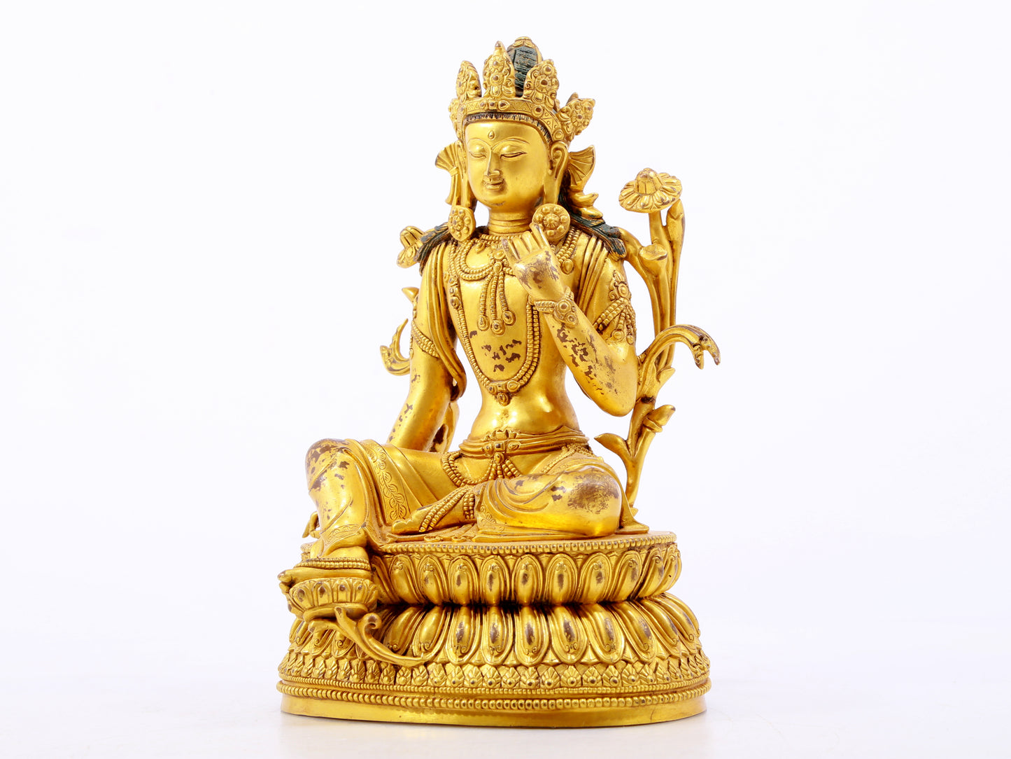 A serene gilt bronze green Tara statue