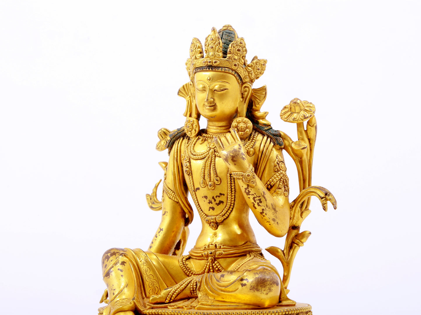 A serene gilt bronze green Tara statue