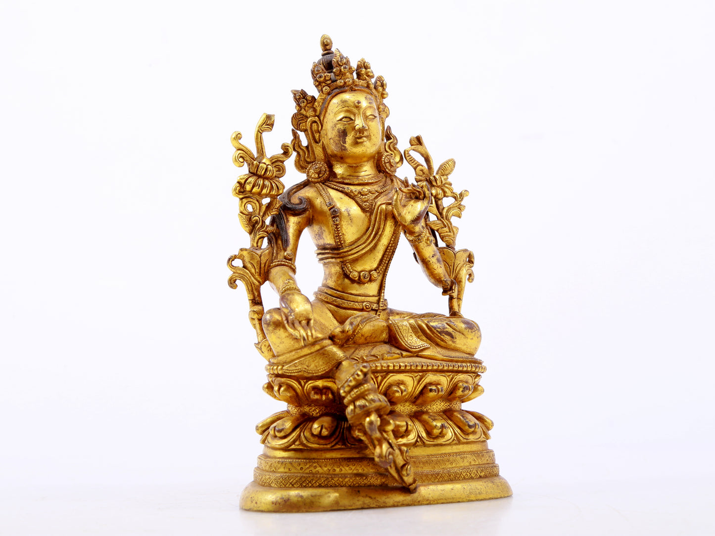 A serene gilt bronze green Tara statue