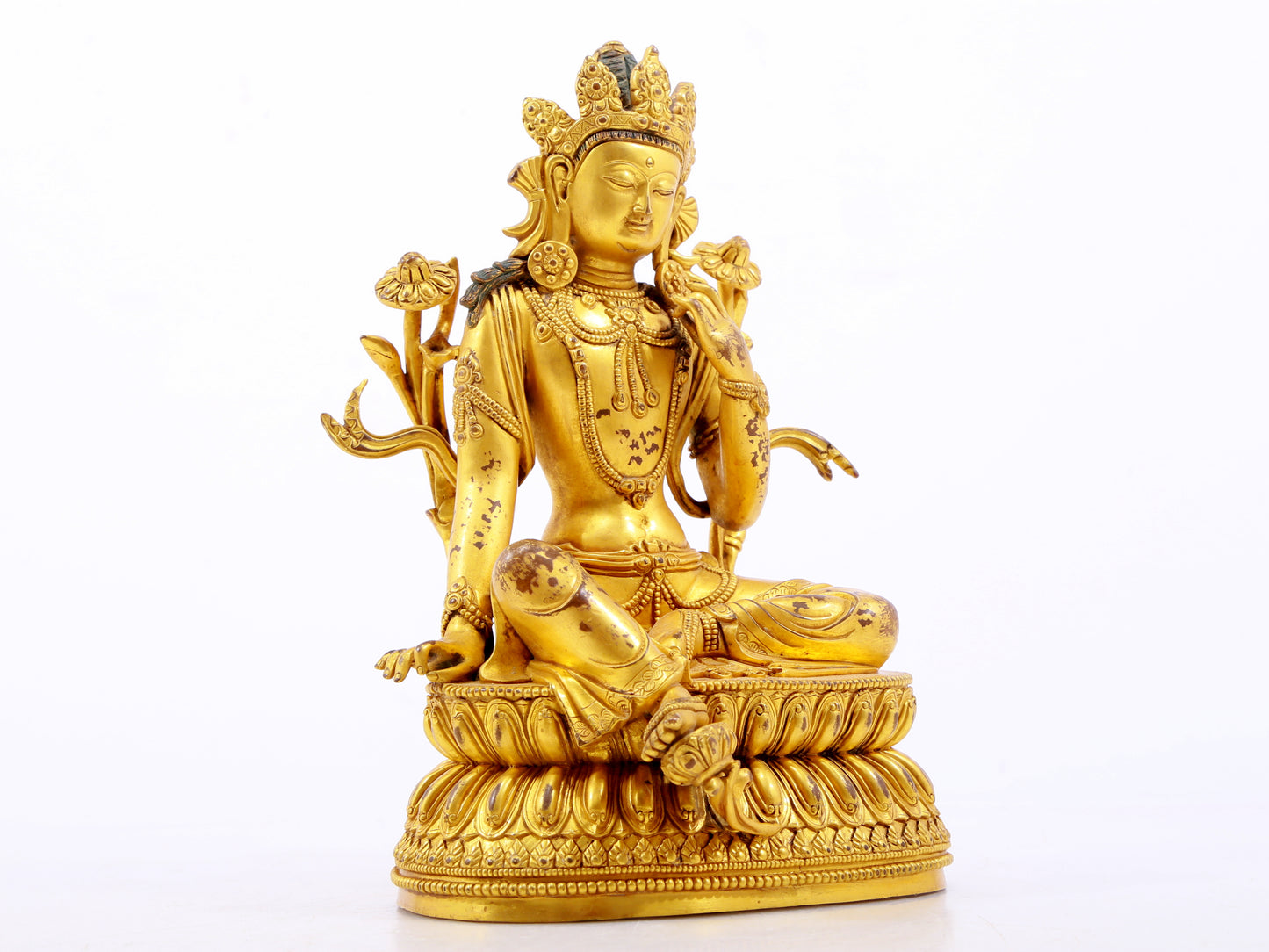 A serene gilt bronze green Tara statue