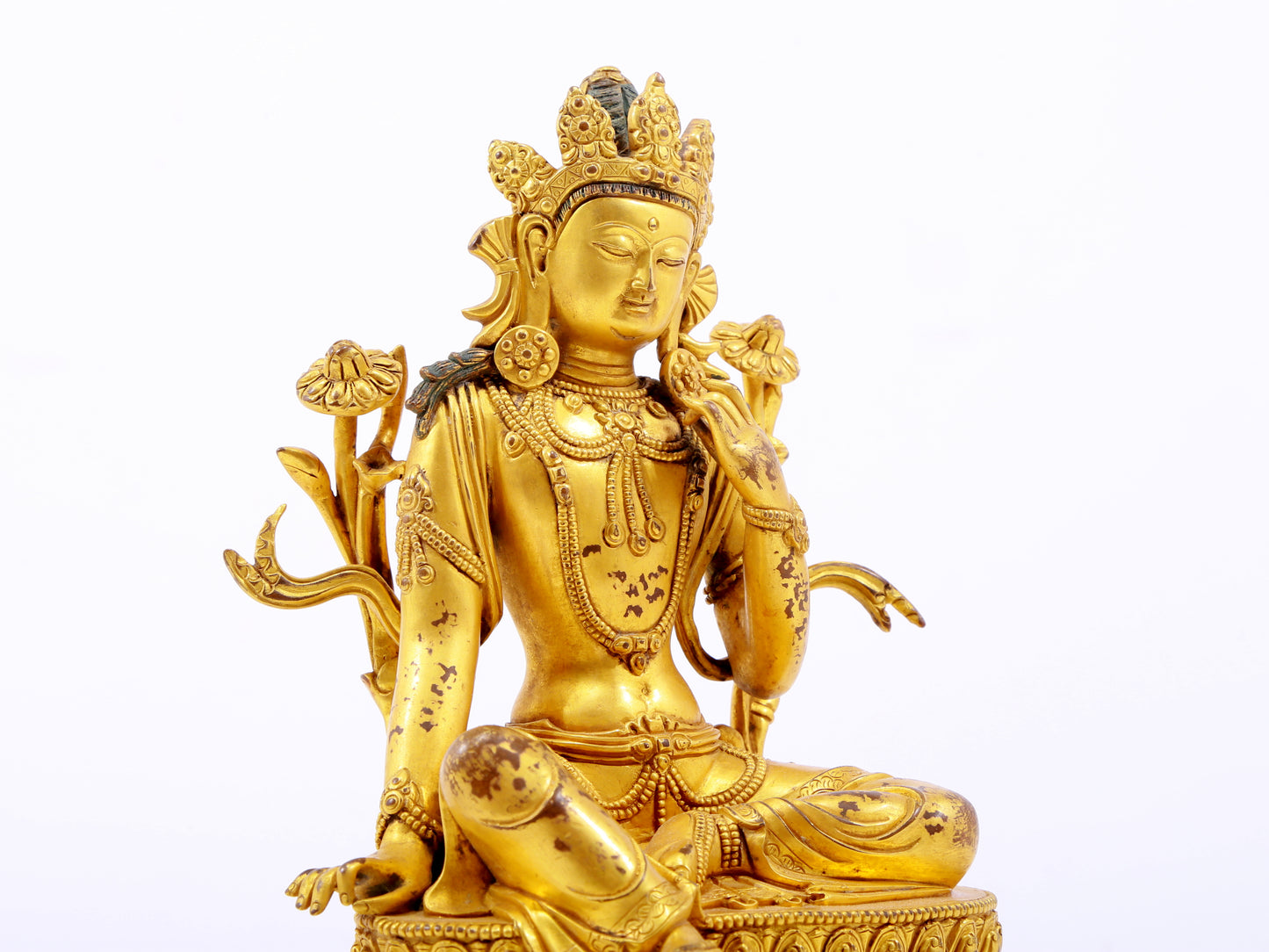 A serene gilt bronze green Tara statue