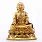 A serene gilt bronze statue of the master