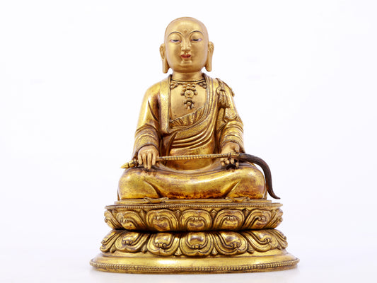 A serene gilt bronze statue of the master