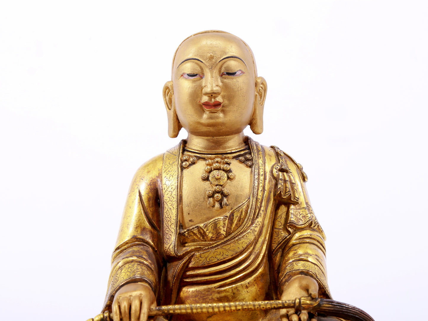 A serene gilt bronze statue of the master