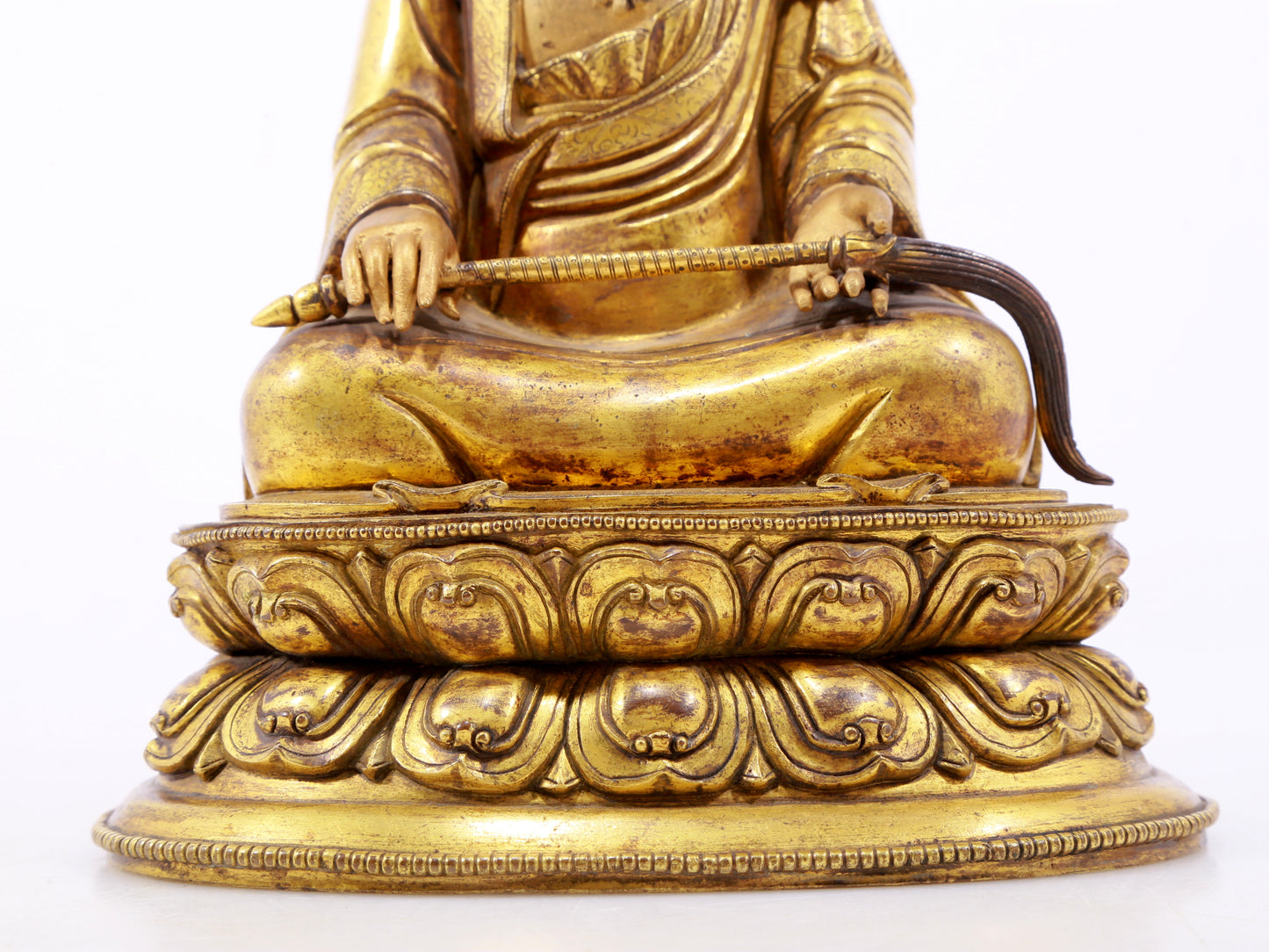 A serene gilt bronze statue of the master