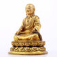 A serene gilt bronze statue of the master