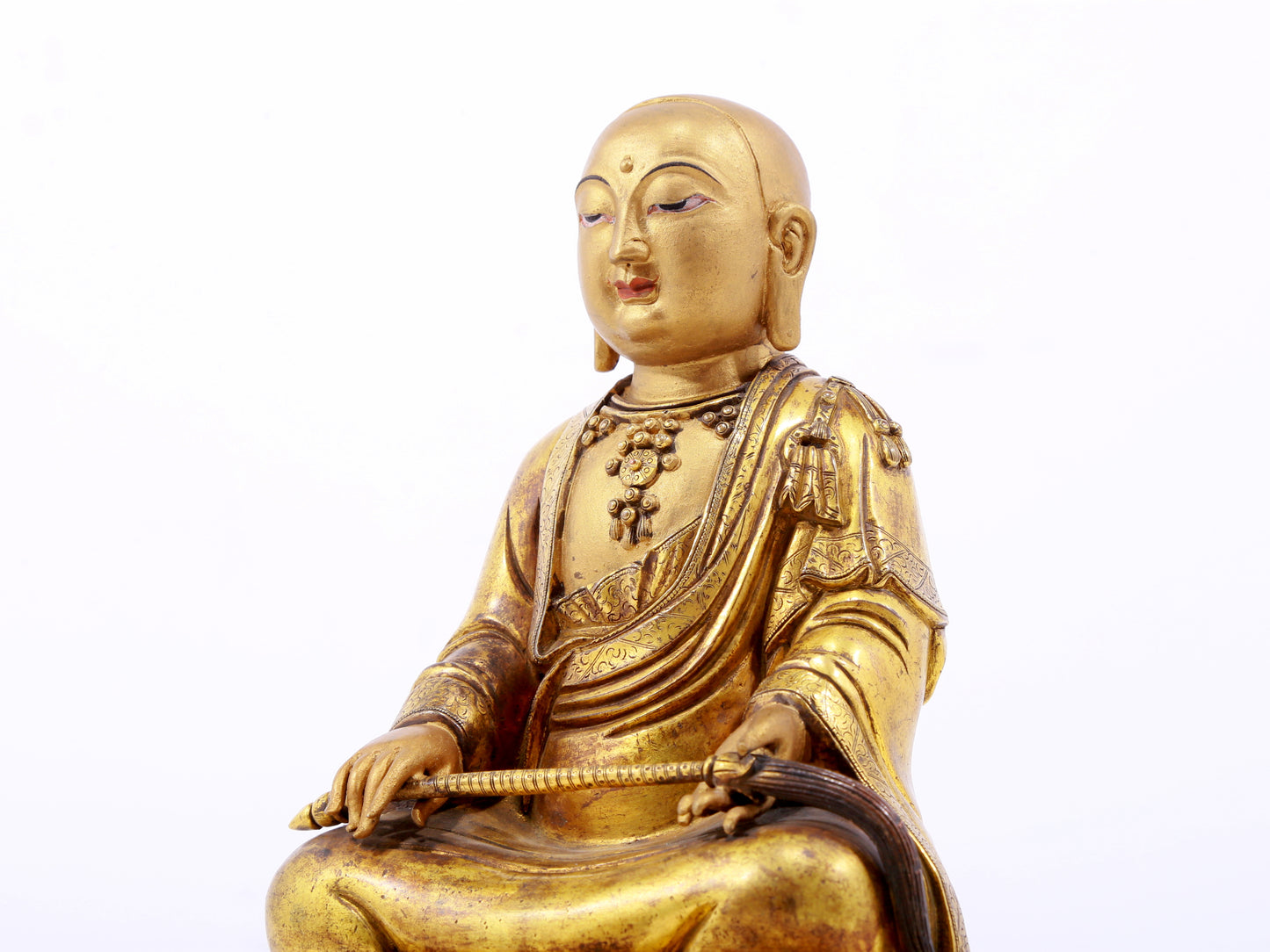 A serene gilt bronze statue of the master