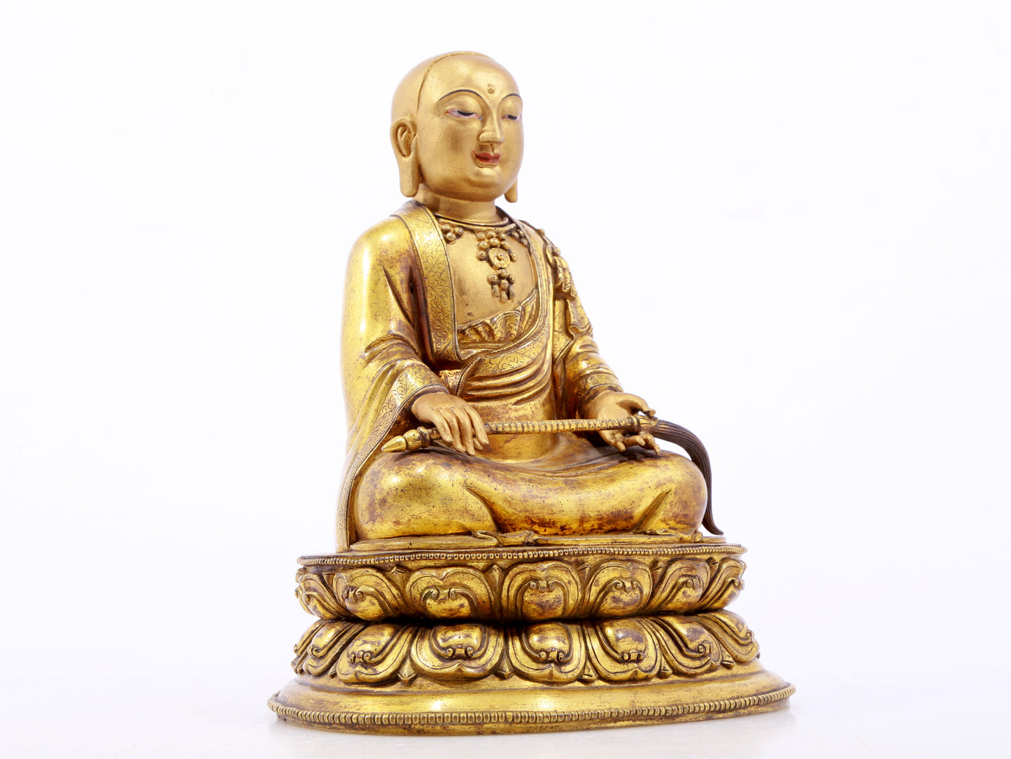 A serene gilt bronze statue of the master