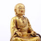 A serene gilt bronze statue of the master