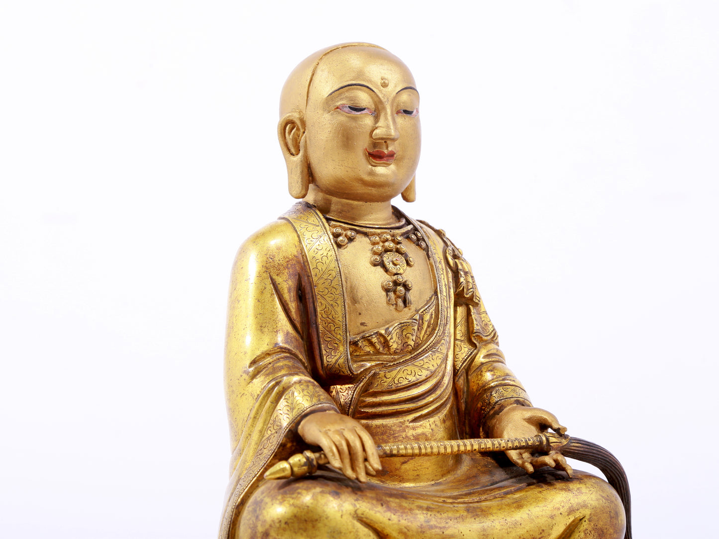 A serene gilt bronze statue of the master