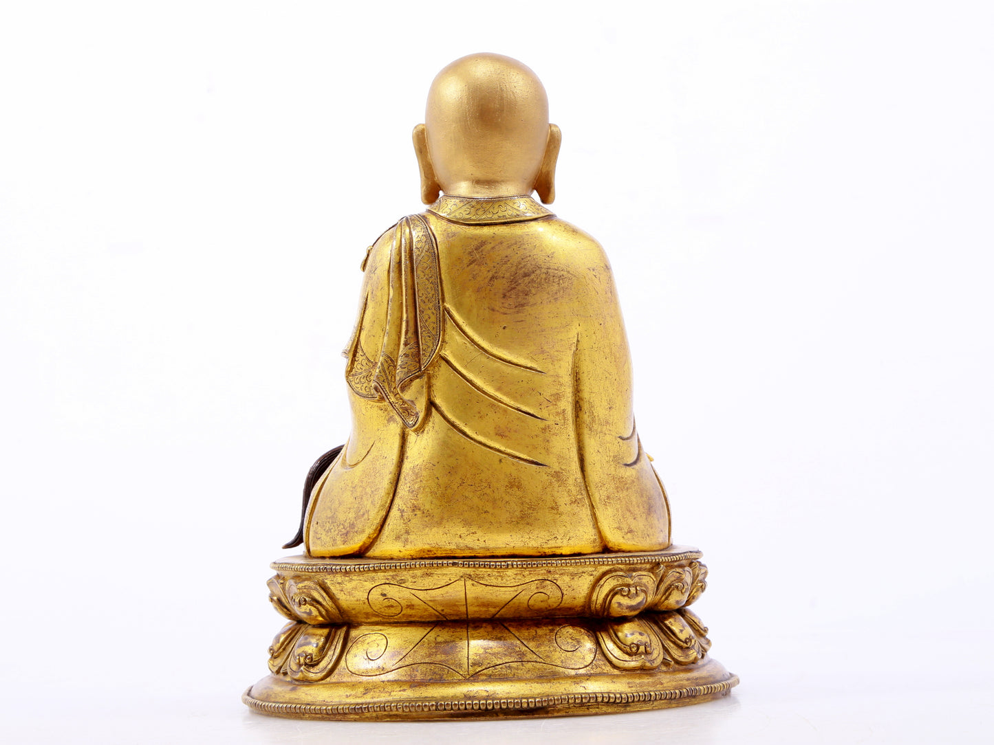 A serene gilt bronze statue of the master