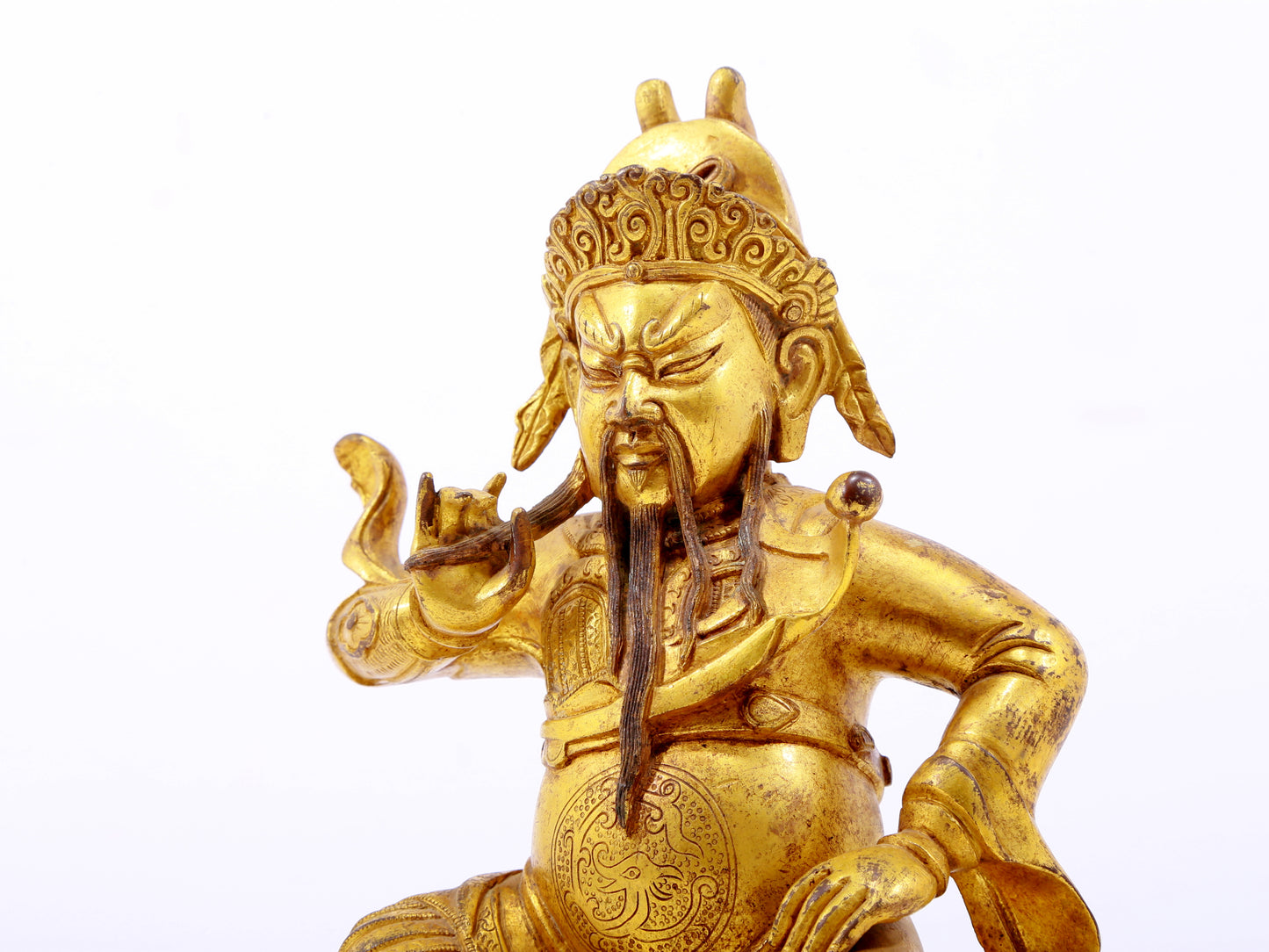 A serene gilt bronze statue of Guan Gong,