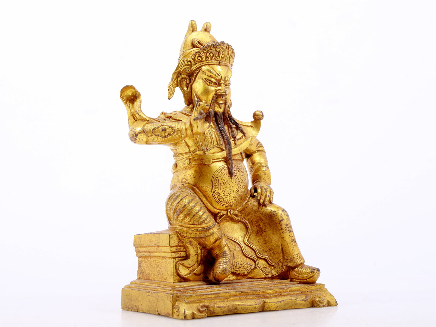 A serene gilt bronze statue of Guan Gong,