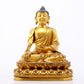 A serene gilt bronze statue of Gautama Buddha