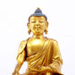 A serene gilt bronze statue of Gautama Buddha