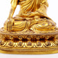 A serene gilt bronze statue of Gautama Buddha