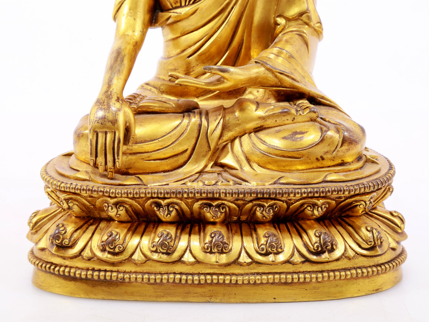 A serene gilt bronze statue of Gautama Buddha