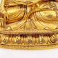 A serene gilt bronze statue of Gautama Buddha