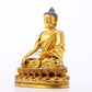 A serene gilt bronze statue of Gautama Buddha