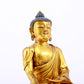 A serene gilt bronze statue of Gautama Buddha