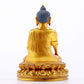 A serene gilt bronze statue of Gautama Buddha