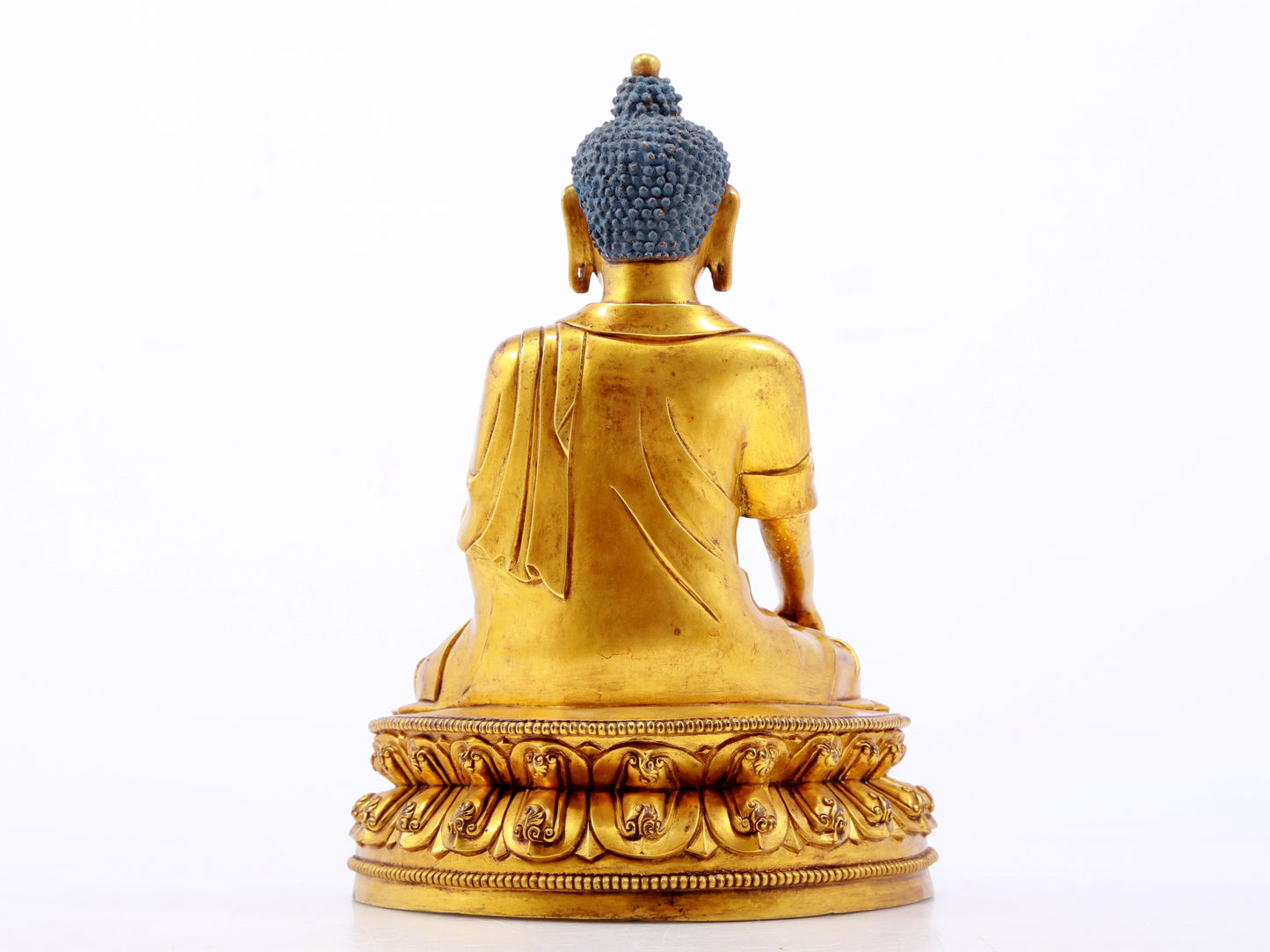 A serene gilt bronze statue of Gautama Buddha