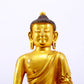 A serene gilt bronze statue of Gautama Buddha