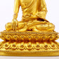 A serene gilt bronze statue of Gautama Buddha