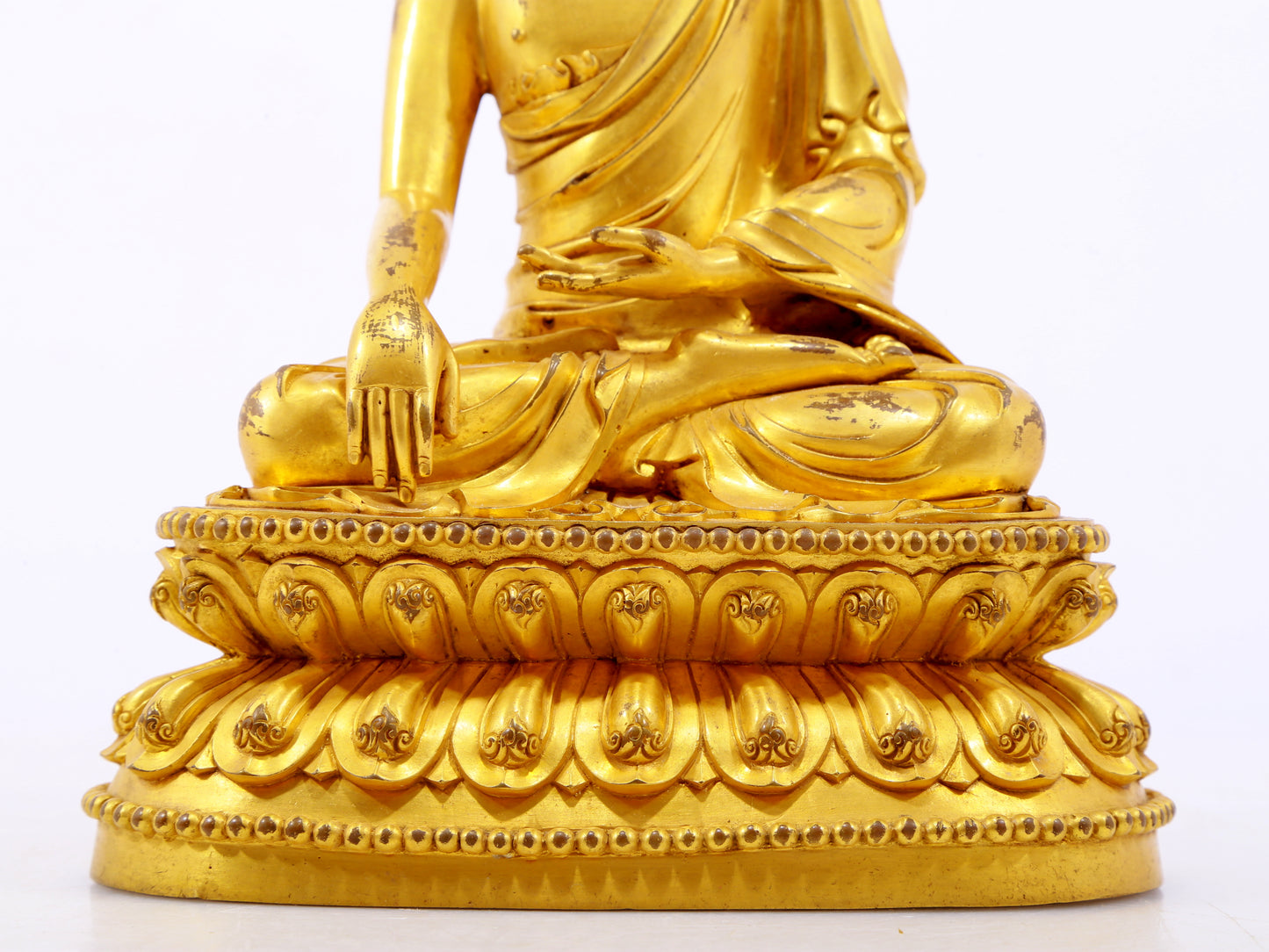 A serene gilt bronze statue of Gautama Buddha