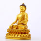 A serene gilt bronze statue of Gautama Buddha