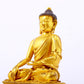 A serene gilt bronze statue of Gautama Buddha