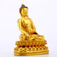 A serene gilt bronze statue of Gautama Buddha