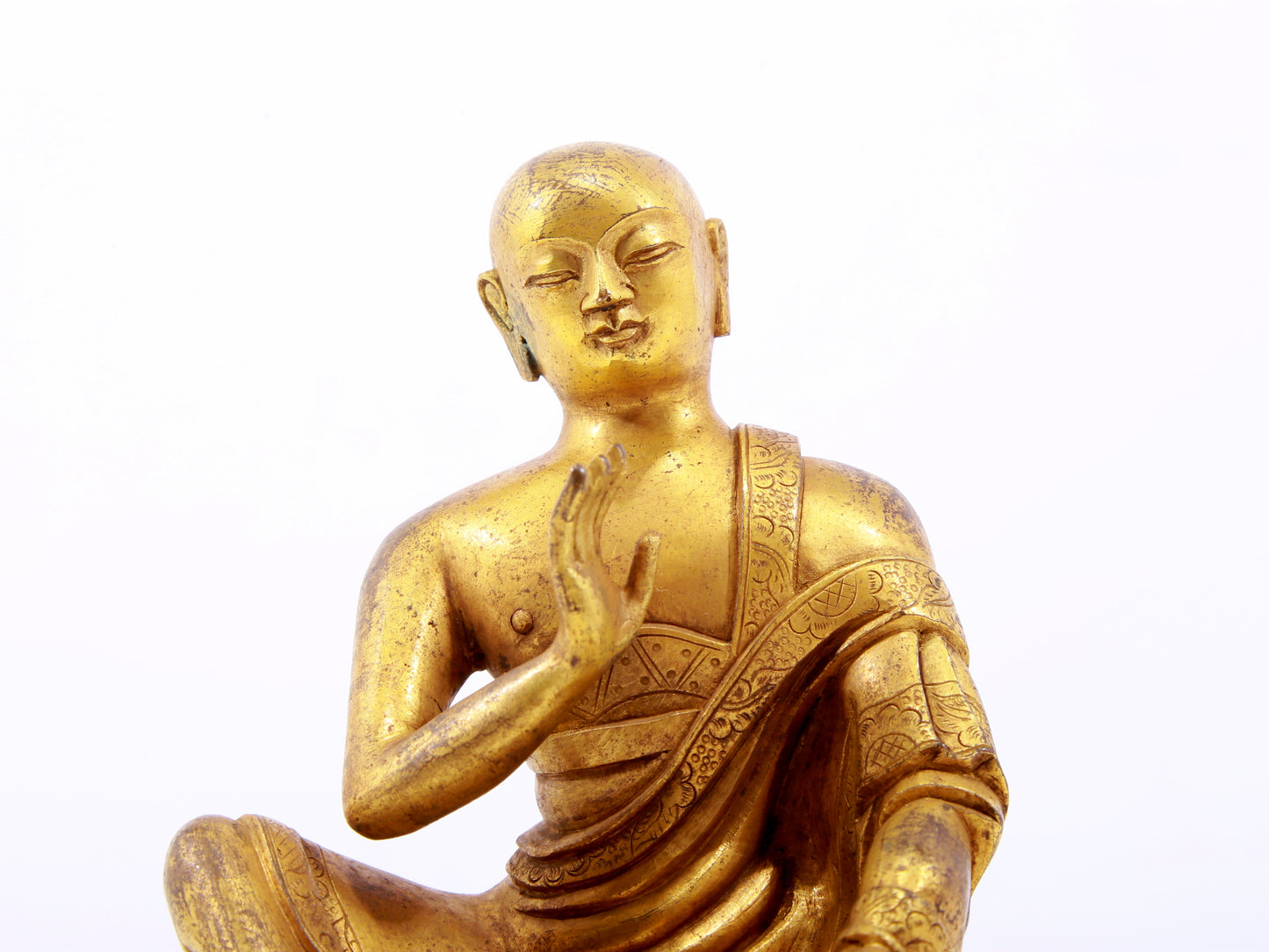 A serene gilt bronze Arhat statue,