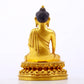 A serene gilt bronze statue of Gautama Buddha