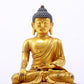 A serene gilt bronze statue of Gautama Buddha