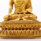 A serene gilt bronze statue of Gautama Buddha